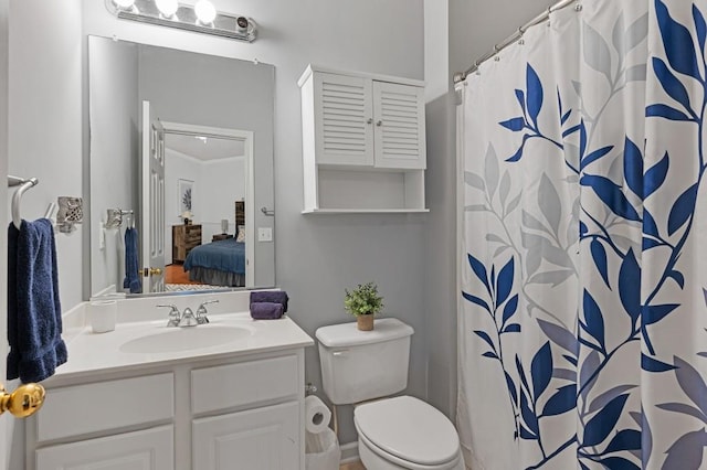 bathroom with vanity, curtained shower, ornamental molding, and toilet