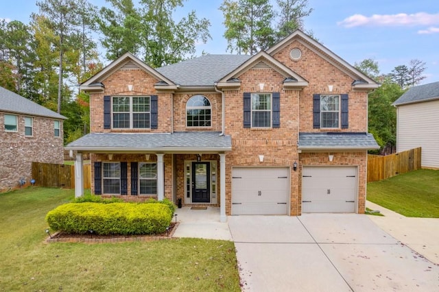 craftsman inspired home featuring a front lawn and a garage