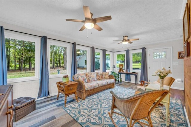 sunroom / solarium featuring ceiling fan