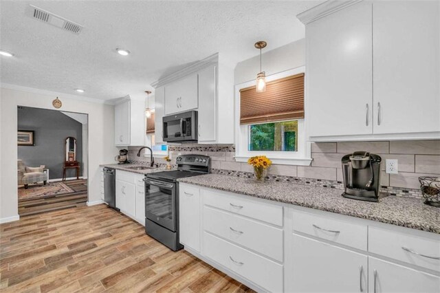 kitchen with sink, hanging light fixtures, stainless steel appliances, light hardwood / wood-style flooring, and white cabinets