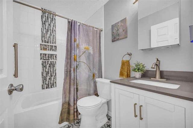 full bathroom with vanity, toilet, shower / bathtub combination with curtain, and a textured ceiling