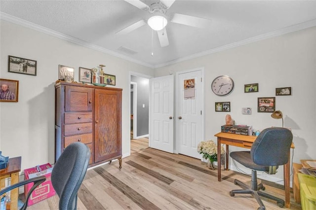 home office with ceiling fan, light hardwood / wood-style floors, and ornamental molding