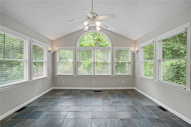 unfurnished sunroom featuring a healthy amount of sunlight and vaulted ceiling