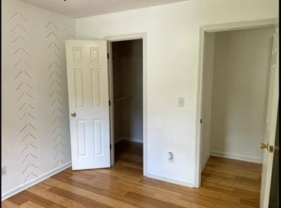 279 Fairview Dr, Dallas, GA 30157 - unfurnished bedroom featuring wood finished floors, baseboards, and a spacious closet