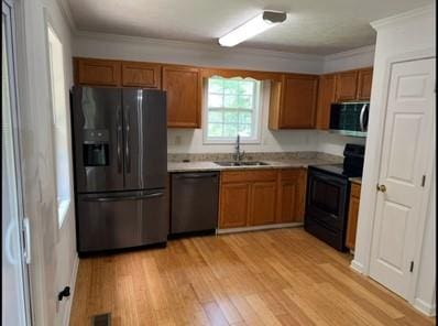 279 Fairview Dr, Dallas, GA 30157 - kitchen featuring black appliances, a sink, brown cabinets, light countertops, and ornamental molding