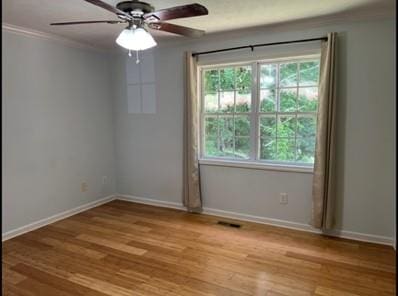 279 Fairview Dr, Dallas, GA 30157 - empty room featuring healthy amount of natural light, crown molding, wood finished floors, baseboards, and a ceiling fan