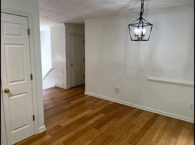 279 Fairview Dr, Dallas, GA 30157 - unfurnished dining area featuring baseboards, a chandelier, and wood finished floors
