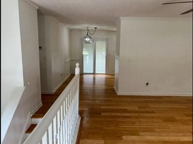 279 Fairview Dr, Dallas, GA 30157 - corridor with wood finished floors, a chandelier, and baseboards
