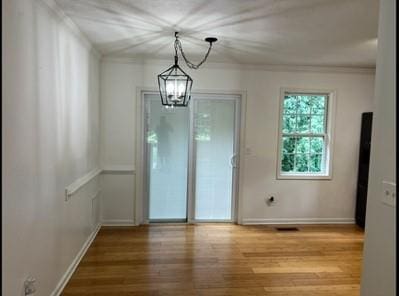 279 Fairview Dr, Dallas, GA 30157 - unfurnished dining area featuring a chandelier, wood finished floors, crown molding, and baseboards