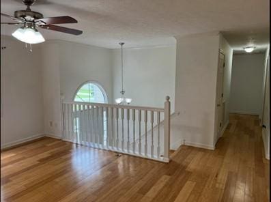 279 Fairview Dr, Dallas, GA 30157 - empty room featuring ceiling fan, wood finished floors, a chandelier, and baseboards