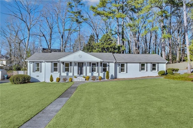 ranch-style home with a front yard and covered porch