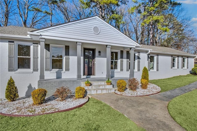 view of front facade with a front lawn and a porch