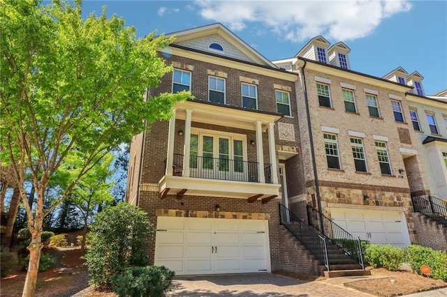 823 Canterbury Overlook, Atlanta, GA 30324 - townhome / multi-family property with an attached garage, driveway, and brick siding