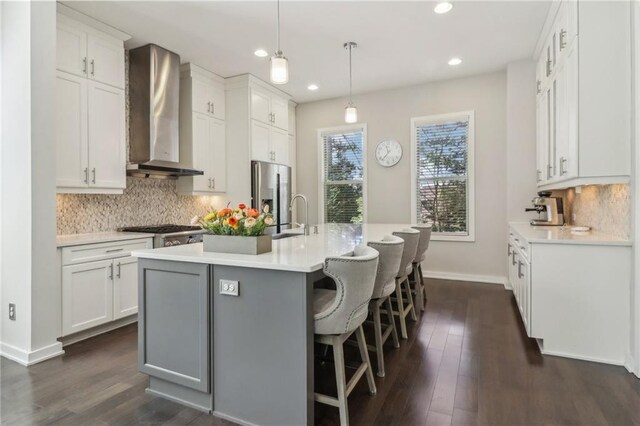 823 Canterbury Overlook, Atlanta, GA 30324 - kitchen featuring stainless steel fridge with ice dispenser, dark wood finished floors, wall chimney range hood, recessed lighting, and a sink