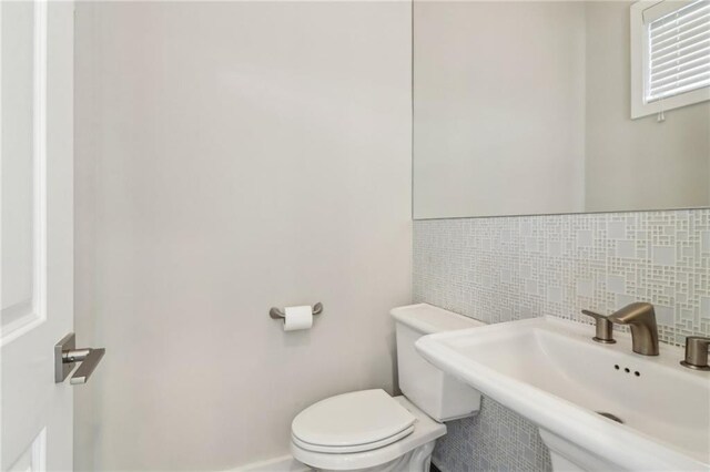 823 Canterbury Overlook, Atlanta, GA 30324 - half bathroom with toilet, a sink, and backsplash