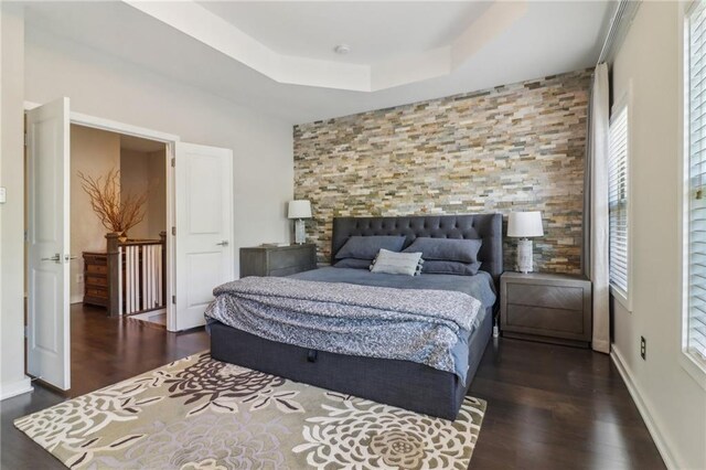 823 Canterbury Overlook, Atlanta, GA 30324 - bedroom featuring a tray ceiling and wood finished floors