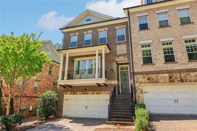 823 Canterbury Overlook, Atlanta, GA 30324 - multi unit property featuring a garage, brick siding, a balcony, and decorative driveway