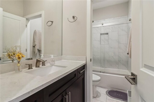 823 Canterbury Overlook, Atlanta, GA 30324 - bathroom with combined bath / shower with glass door, tile patterned flooring, vanity, and toilet