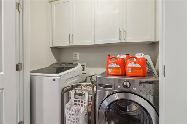 823 Canterbury Overlook, Atlanta, GA 30324 - washroom with cabinet space and washing machine and dryer