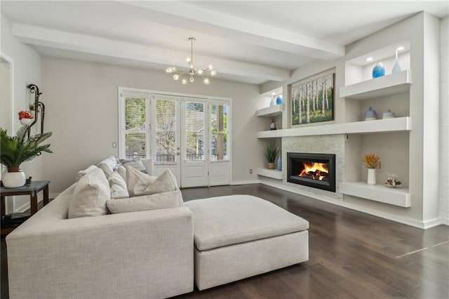 823 Canterbury Overlook, Atlanta, GA 30324 - living area featuring baseboards, a stone fireplace, a chandelier, beamed ceiling, and dark wood finished floors