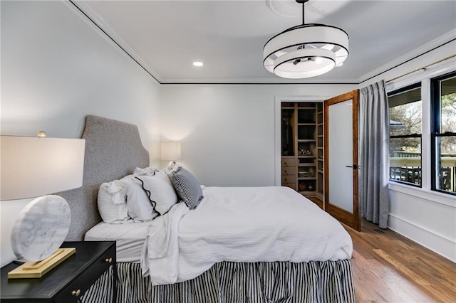 bedroom with wood-type flooring and ornamental molding