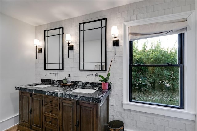 bathroom featuring tasteful backsplash, vanity, and tile walls