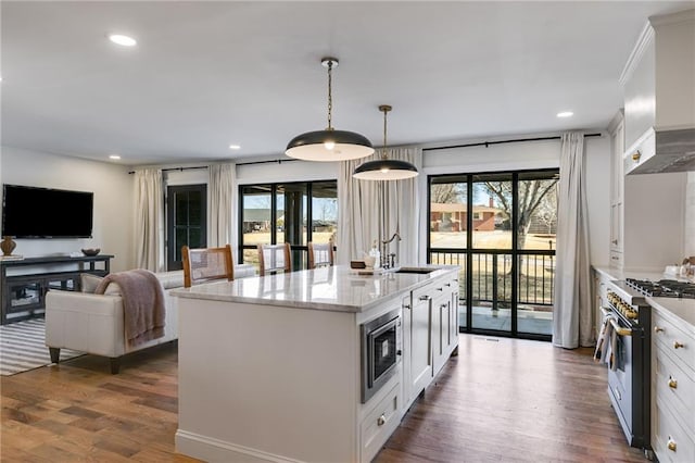 kitchen featuring white cabinetry, appliances with stainless steel finishes, and decorative light fixtures