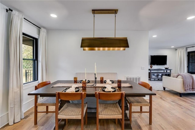 dining space with light hardwood / wood-style flooring