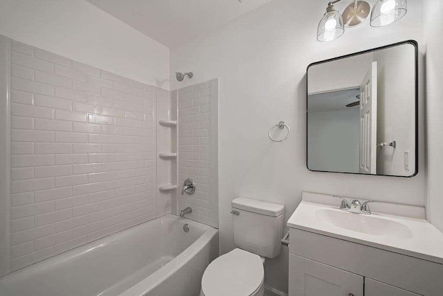 bathroom with bathtub / shower combination, vanity, and toilet