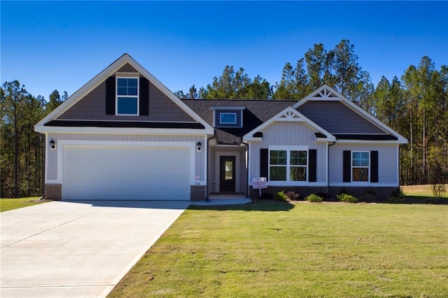 craftsman inspired home with a garage and a front lawn