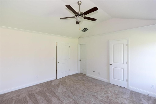 unfurnished bedroom with vaulted ceiling, light colored carpet, and ceiling fan