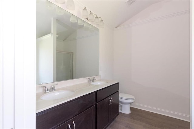 bathroom featuring vaulted ceiling, hardwood / wood-style flooring, vanity, toilet, and a shower with door