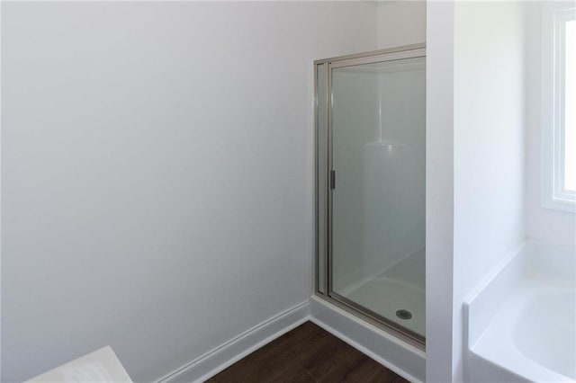 bathroom featuring hardwood / wood-style floors and shower with separate bathtub