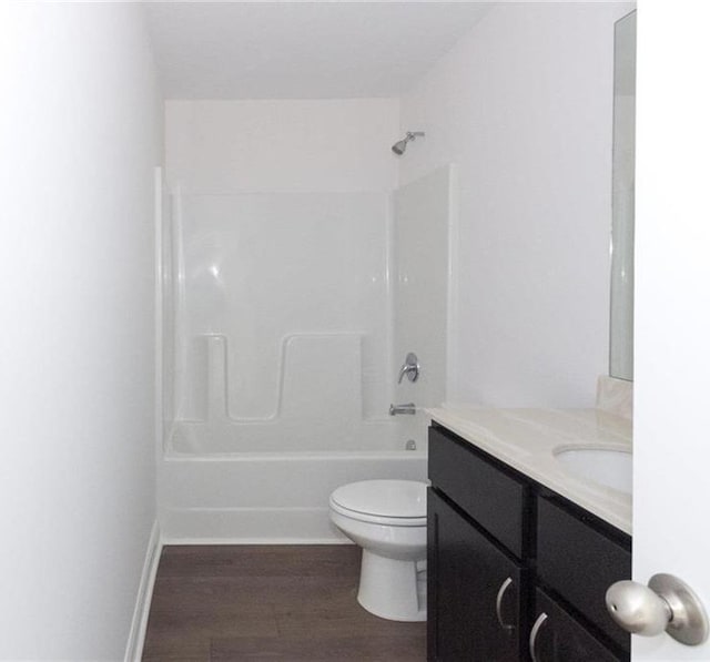 full bathroom with toilet, vanity, bathtub / shower combination, and hardwood / wood-style floors