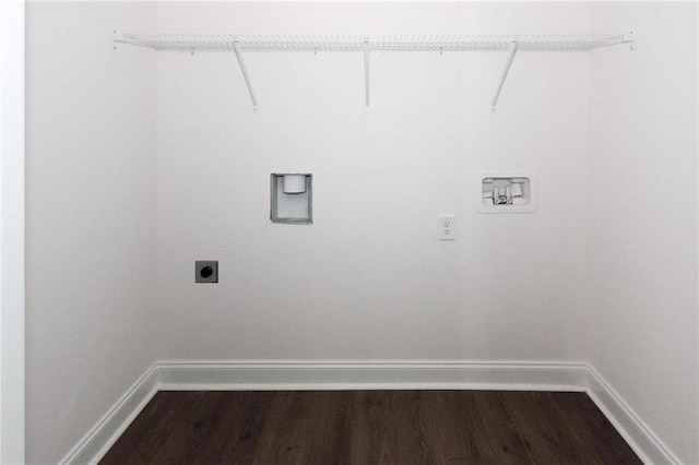 washroom with dark hardwood / wood-style flooring and electric dryer hookup