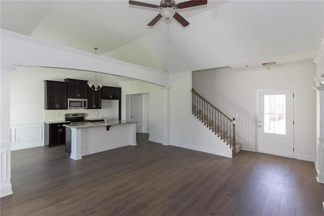 unfurnished living room with ceiling fan, dark hardwood / wood-style flooring, and vaulted ceiling