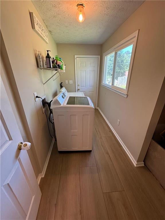 190 Grayland Creek Dr, Lawrenceville, GA 30046 - laundry area with a textured ceiling, baseboards, wood finished floors, and washing machine and dryer
