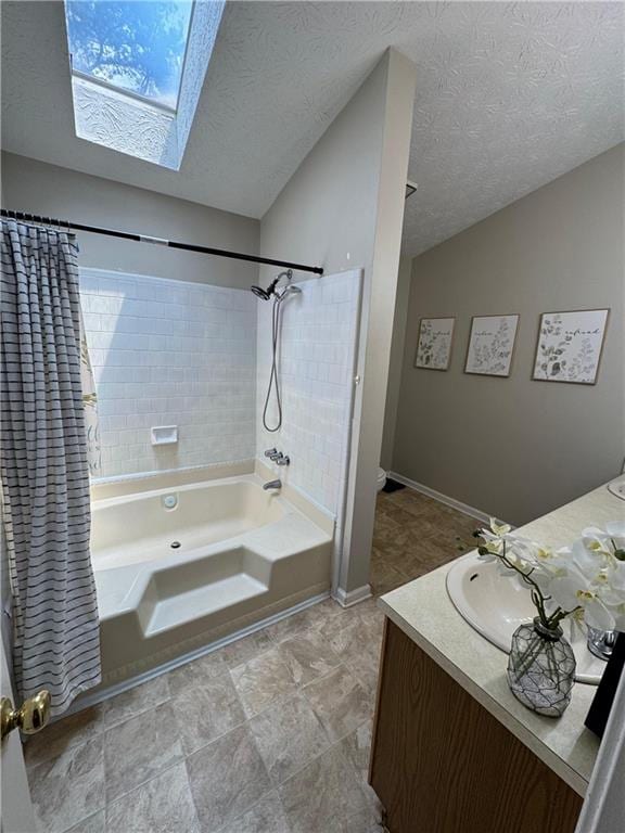 190 Grayland Creek Dr, Lawrenceville, GA 30046 - bathroom featuring a skylight, vanity, shower / tub combo with curtain, a textured ceiling, and lofted ceiling