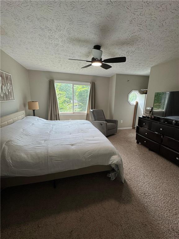 190 Grayland Creek Dr, Lawrenceville, GA 30046 - carpeted bedroom featuring ceiling fan, a textured ceiling, and baseboards