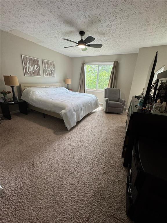 190 Grayland Creek Dr, Lawrenceville, GA 30046 - carpeted bedroom with a textured ceiling and ceiling fan
