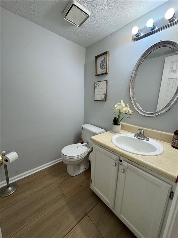 190 Grayland Creek Dr, Lawrenceville, GA 30046 - half bath with toilet, wood finished floors, vanity, and a textured ceiling