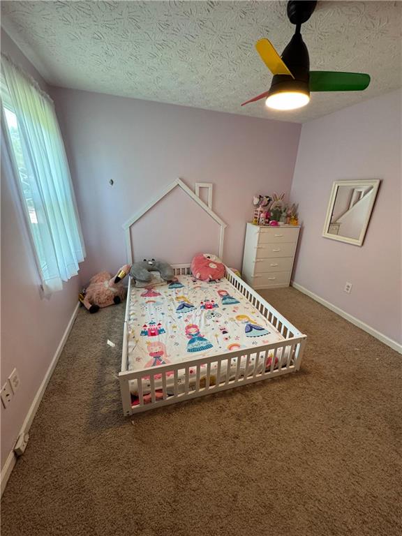 190 Grayland Creek Dr, Lawrenceville, GA 30046 - bedroom with a textured ceiling, carpet floors, a ceiling fan, and baseboards