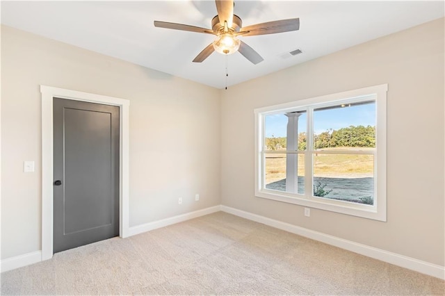 carpeted empty room with ceiling fan