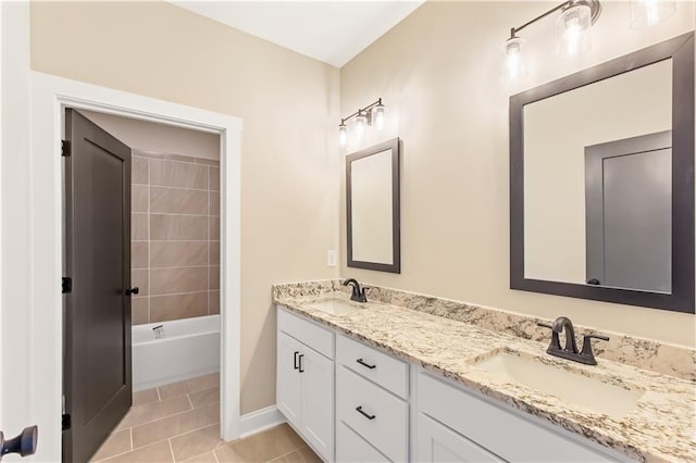 bathroom featuring tile patterned floors, vanity, and tiled shower / bath combo