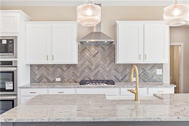 kitchen featuring white cabinets and hanging light fixtures