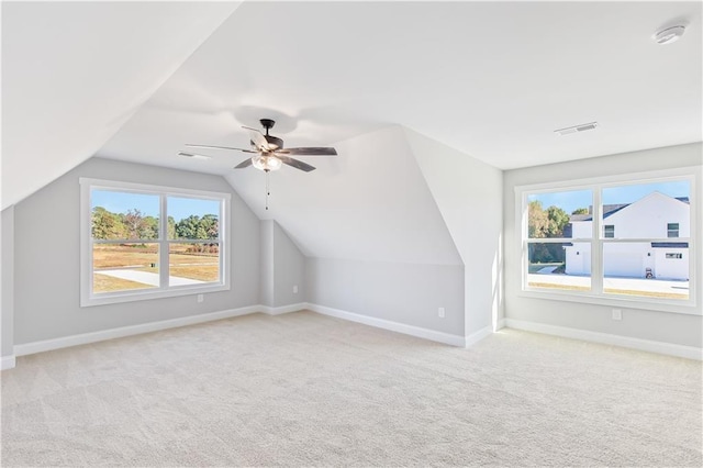 bonus room featuring ceiling fan, lofted ceiling, and light carpet