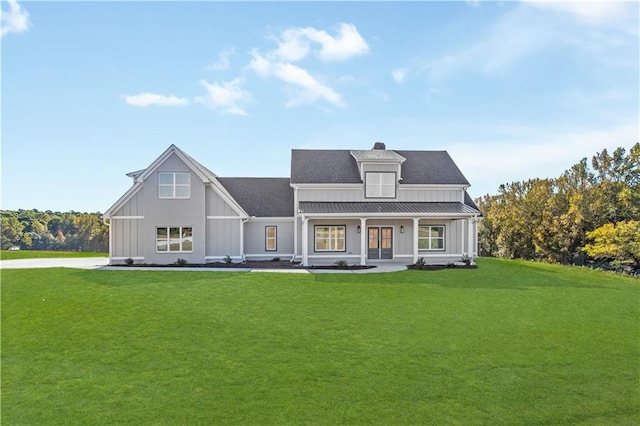 back of house featuring a porch and a yard