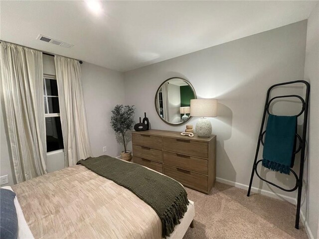 bedroom featuring light colored carpet, visible vents, and baseboards