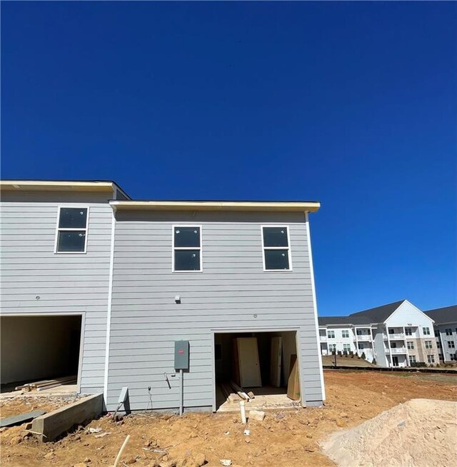 rear view of house featuring a garage