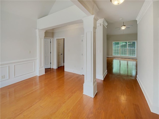 6405 Beaver Creek Trl, Atlanta, GA 30349 - spare room with crown molding, a ceiling fan, decorative columns, and light wood-style floors